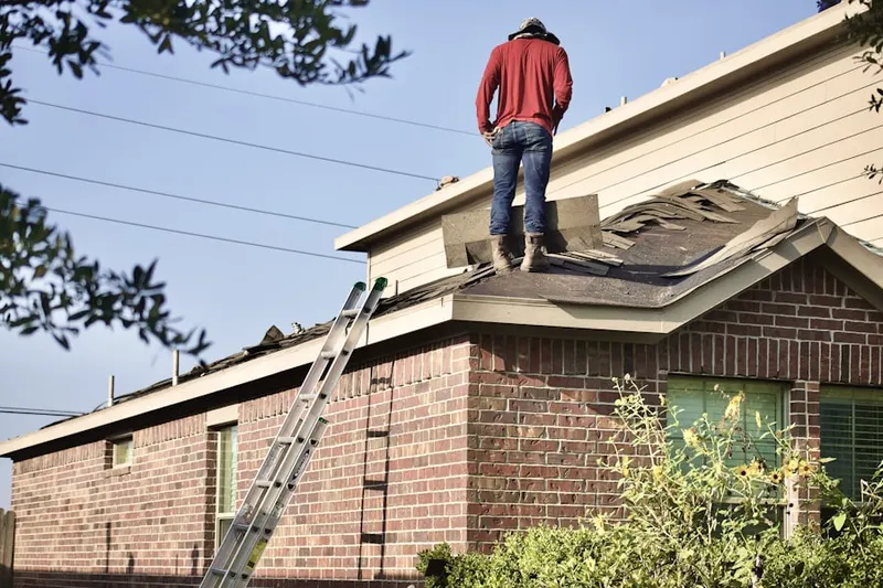 Professional roofer working on a residential roof in Indiantown
